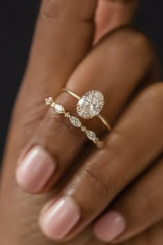 a woman's hand holding a diamond ring with the words melanie casey on it