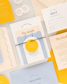 the wedding stationery is laid out on top of each other