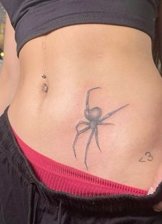 a woman with a spider tattoo on her stomach