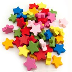 colorful wooden stars are scattered on a white surface