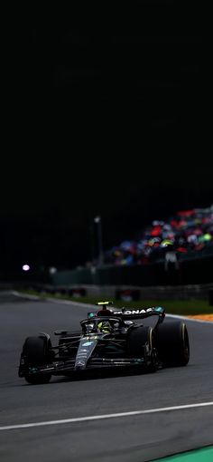 a race car driving down the track at night