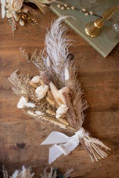 dried flowers and feathers on a wooden table