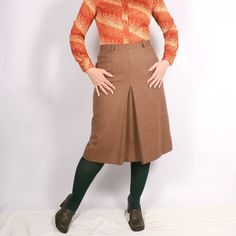 "Vintage Italian 70s Pure New Wool plaid front pleat skirt in beige S/M, Academia smart casual skirt 30s 40s style - A-shaped secretary, business, work, office, smart casual skirt - Similar to 30s and 40s style - Medium weight fabric, lined - Zip closure - High-waisted - Brand: Variable Firenze - 100% pure new wool, lining estimated viscose - Excellent mint vintage condition - Tag size I46, estimated S/M, please see exact measurements MORE vintage SKIRTS in my shop: https://www.etsy.com/shop/GoodGrooves?ref=simple-shop-header-name&listing_id=1308389865§ion_id=39276826 ✿ MEASUREMENTS (taken flat) ✿ 27.5\" / 70  cm length 15.5'' / 39.5 cm waist I have M in the waist (30''/ 76 cm) and L in the hips (41.5'' / 106 cm) - it was a slightly small fit. My height - 5'7 / 170cm. This is true vintage, Fitted Brown Pleated Skirt Bottoms, Fitted Beige Bottoms With Accordion Pleats, Brown Pleated Midi Skirt For Work, Fitted Full Brown Pleated Skirt, Fitted Full Pleated Brown Skirt, Classic Fitted Pleated Pencil Skirt, Brown Pleated Skirt For Work, Beige Fitted Knee-length Pleated Skirt, Vintage Brown Knee-length Skirt