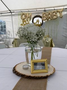 a vase filled with baby's breath flowers on top of a white table cloth