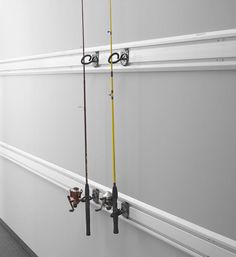 there are two fishing rods hanging on the wall