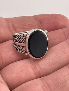 Add a touch of elegance to your outfit with this stunning black onyx ring. Crafted from 925 sterling silver, this ring features a beautiful black onyx stone with a secondary black onyx stone. The ring is available in size 11 and weighs 11.3 grams. Perfect for any occasion, this ring is sure to make a statement. The brand of this ring is BS 925 and the metal purity is 925. The main stone color is black, and the metal is sterling silver 925 Classic Black Gemstone Ring, Elegant Black Signet Ring For Formal Occasions, Classic Black Sterling Silver Signet Ring, Formal Black Oval Rings, Formal Black Oval Ring, Classic Black Onyx Rings, Formal Black Rings With Polished Finish, Formal Black Ring With Polished Finish, Classic Black Sterling Silver Rings