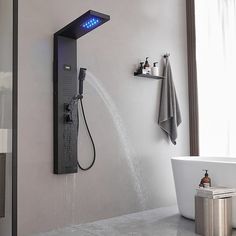 a bathroom with a large shower head next to a bath tub