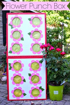 the flower punch box is next to a potted plant with pink flowers on it