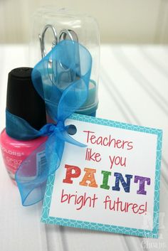 there is a small jar with scissors in it and a sign that says teachers like you paint bright futures