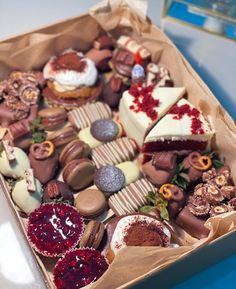 a box filled with lots of different types of desserts