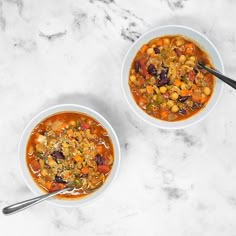 two bowls of soup on a marble table