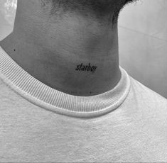 a man's neck with the word yoshi tattooed on his left side ribcage