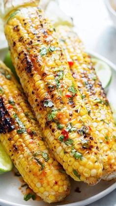 grilled corn on the cob with lime wedges and cilantro sauce