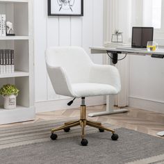 a white office chair sitting on top of a rug in front of a computer desk