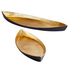 two gold oval trays with black rims on each side, one is empty and the other has a curved edge