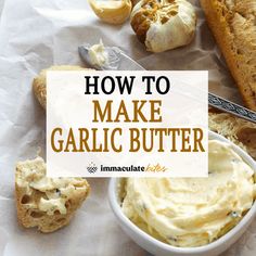 an image of garlic butter in a bowl with bread and garlic on the table next to it