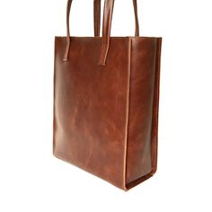 "Tote bag from SHleatnerBags keeps up with the times. The bag has clear lines and holds its shape well. At the same time, the bag is very roomy. Inside the bag there is a pocket with a zipper for small things. Dimensions: Small bag: Height: 11.81\" (30 cm) Width: 9.84\" (25 cm) Depth: 3.15\" (8 cm) Medium bag: Height: 13\" (33 cm) Width: 11.42\" (29 cm) Depth: 3.54\" (9 cm) Large bag: Height: 11.78\" (35 cm) Width: 11.81\" (30 cm) Depth: 5.12\" (13 cm)" Rectangular Box Bag With Leather Handles For Shopping, Classic Rectangular Box Bag For Everyday Use, Classic Box Bag With Double Handle For Gift, Modern Brown Rectangular Bag, Classic Bags With Leather Handles For Gift, Classic Bags With Top Carry Handle For Gifts, Classic Square Box Bag With Leather Handles, Classic Bag With Top Carry Handle, Square Business Bags With Leather Handles