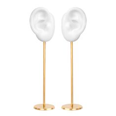 two gold and white ear stands on top of each other