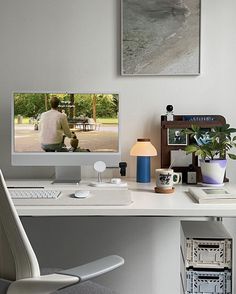 a white desk with a computer monitor and keyboard