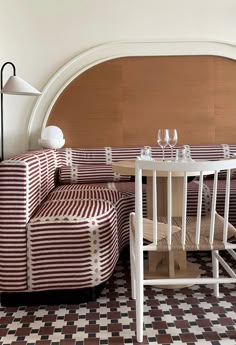 a table and chairs in a room with checkered flooring