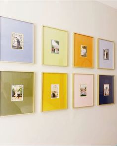 a wall with many different colored frames on it