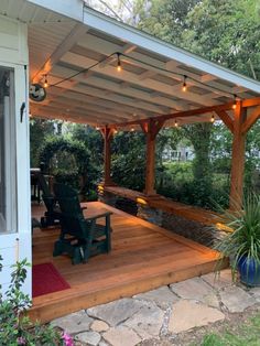 a covered patio with chairs and lights on it