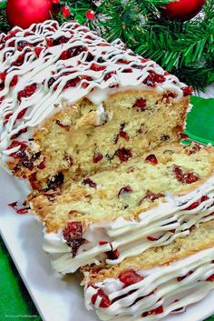 a cake with white frosting and cranberries on it sitting on a plate