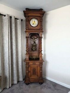 an old grandfather clock in the corner of a room