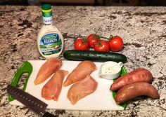 raw chicken and vegetables on a cutting board