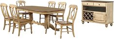 a dining room table with six chairs and a cabinet