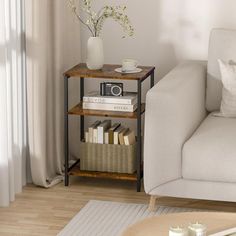 a living room with a couch, coffee table and bookshelf in the corner