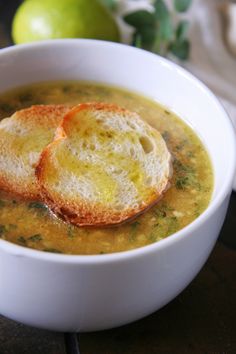 two pieces of bread sit in a bowl of soup