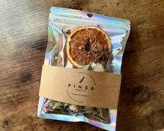 a bag of dried oranges sitting on top of a wooden table