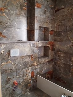 a bathroom that is being remodeled with marble walls