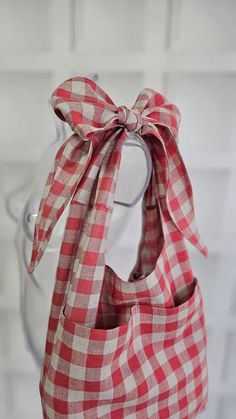 a red and white checkered bag with a large bow on the top of it