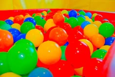 there are many different colored balls in the ball pit