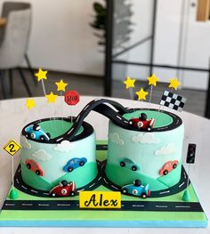 a birthday cake with two cars on it