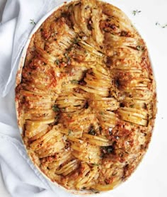 an image of a pie that is on a white tablecloth and it has been cut into pieces