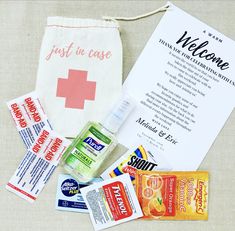 an assortment of personal care items laid out on a table next to a welcome bag