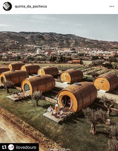 an aerial view of several wooden barrels in a field