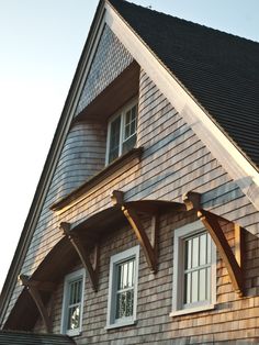 an image of a house that is made out of wood and shingled roofing