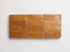 several square pieces of bread sitting on top of each other in front of a white wall