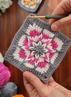 someone is crocheting a square in the shape of a flower