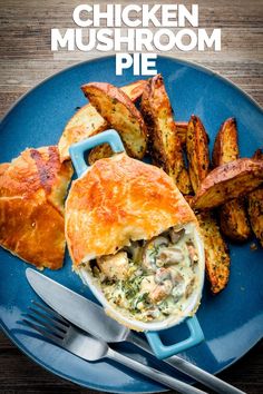 a blue plate topped with food next to french fries and potato wedges on top of a wooden table