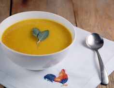 a bowl of soup on a napkin with a spoon