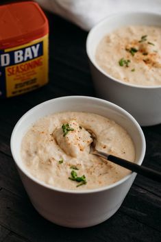 two white bowls filled with dip and garnished with parsley on the side