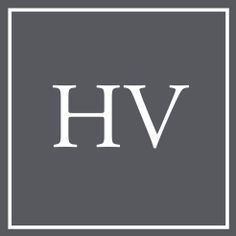 the hv logo is shown in white on a gray background with black and white lettering