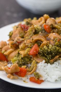 a white plate topped with rice and broccoli covered in sauce