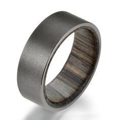 a wedding ring with wood inlays on the outside and inside, made from stainless steel