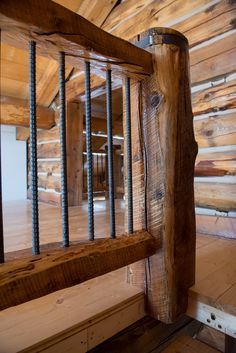 the inside of a log cabin with metal bars